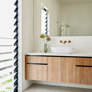 Mid-sized contemporary master bathroom in Geelong with furniture-like cabinets, medium wood cabinets, white tile, ceramic tile, terra-cotta floors, a vessel sink, engineered quartz benchtops, white floor, white benchtops, a single vanity and a floating vanity.