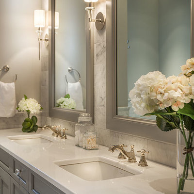 Large transitional master gray tile, white tile and marble tile marble floor freestanding bathtub photo in Other with gray cabinets, gray walls, an undermount sink, recessed-panel cabinets and solid surface countertops