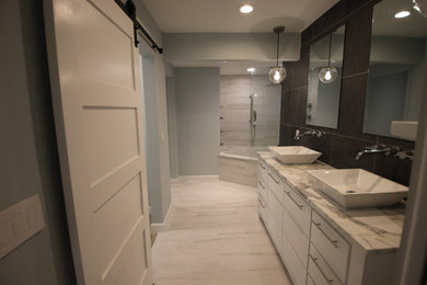 Inspiration for a mid-sized contemporary master multicolored tile and porcelain tile porcelain tile and white floor bathroom remodel in Orlando with flat-panel cabinets, white cabinets, multicolored walls, a vessel sink, quartzite countertops, a hinged shower door and multicolored countertops