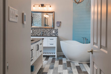 Bathroom - large transitional master gray tile and porcelain tile porcelain tile bathroom idea in Philadelphia with shaker cabinets, white cabinets, a one-piece toilet, gray walls, an undermount sink, quartz countertops and blue countertops