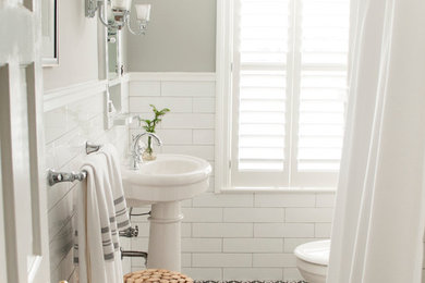 Bathroom - transitional porcelain tile porcelain tile bathroom idea in Other with a two-piece toilet, gray walls and a pedestal sink