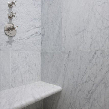 Dramatic all marble shower with bench