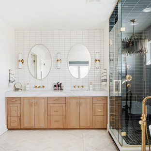 Inspiration for a large transitional master green tile and ceramic tile ceramic tile and beige floor bathroom remodel in Denver with light wood cabinets, white walls, a hinged shower door and white countertops