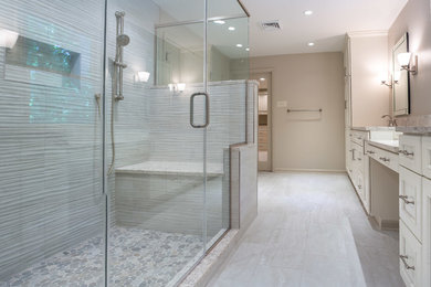 Double shower - contemporary master beige tile ceramic tile double shower idea in Wilmington with recessed-panel cabinets, beige cabinets, a one-piece toilet, beige walls, an undermount sink, quartz countertops and a hinged shower door