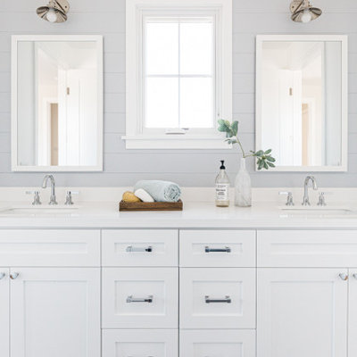 Inspiration for a cottage gray floor and double-sink bathroom remodel in Los Angeles with shaker cabinets, white cabinets, gray walls, an undermount sink and white countertops