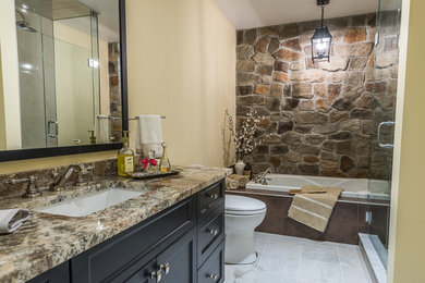 Classic bathroom in Toronto with shaker cabinets, black cabinets, a built-in bath, ceramic tiles, yellow walls, ceramic flooring, a submerged sink and granite worktops.