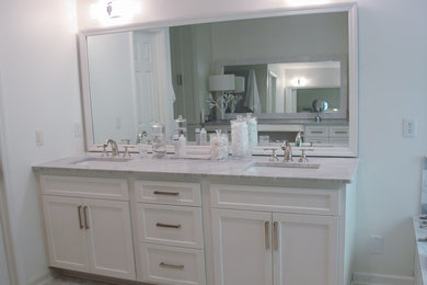 Example of a large minimalist master gray tile and stone tile marble floor bathroom design in Raleigh with shaker cabinets, white cabinets, white walls, an undermount sink and marble countertops