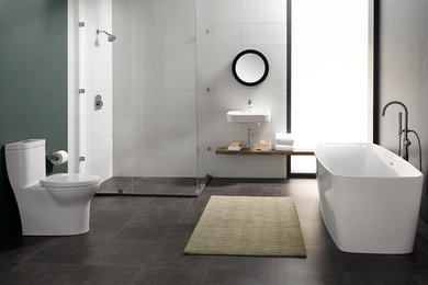 Mid-sized trendy master white tile and glass tile ceramic tile and gray floor bathroom photo in Omaha with open cabinets, medium tone wood cabinets, a one-piece toilet, blue walls, a wall-mount sink and a hinged shower door