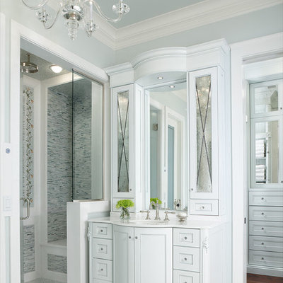 Alcove shower - traditional master gray tile alcove shower idea in Detroit with white cabinets, beaded inset cabinets, blue walls, an undermount sink and solid surface countertops