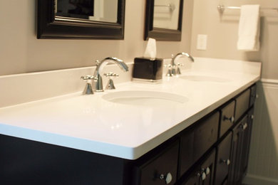 Example of a transitional bathroom design in Birmingham with black cabinets, an undermount sink and quartz countertops