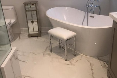 Example of a mid-sized transitional master gray tile, white tile and stone tile marble floor bathroom design in Toronto with shaker cabinets, dark wood cabinets, a one-piece toilet, gray walls and quartz countertops