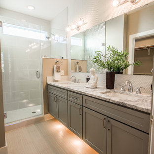Design ideas for a mid-sized contemporary master bathroom in Austin with shaker cabinets, grey cabinets, a corner shower, a two-piece toilet, white tile, glass tile, multi-coloured walls, plywood floors, a drop-in sink and granite benchtops.