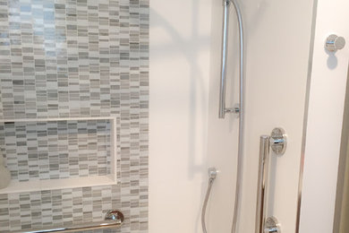 Example of a small minimalist 3/4 white tile and porcelain tile porcelain tile bathroom design in Miami with flat-panel cabinets, dark wood cabinets, solid surface countertops, a one-piece toilet, white walls and an undermount sink