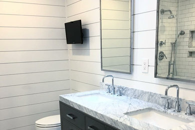 Small transitional 3/4 white tile and subway tile slate floor and gray floor bathroom photo in New York with flat-panel cabinets, black cabinets, a two-piece toilet, white walls, an undermount sink and marble countertops