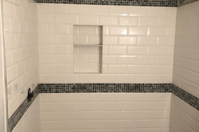 Example of a large transitional master white tile and subway tile limestone floor, gray floor and single-sink bathroom design in New York with white walls, shaker cabinets, white cabinets, limestone countertops, gray countertops, a freestanding vanity, an undermount sink and a one-piece toilet