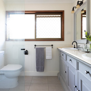 Transitional 3/4 bathroom in Brisbane with raised-panel cabinets, grey cabinets, a corner shower, beige walls, a drop-in sink, beige floor and beige benchtops.