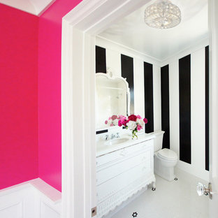 Bathroom - mid-sized eclectic 3/4 ceramic tile and white floor bathroom idea in Austin with furniture-like cabinets, white cabinets, a one-piece toilet, black walls, an integrated sink and white countertops