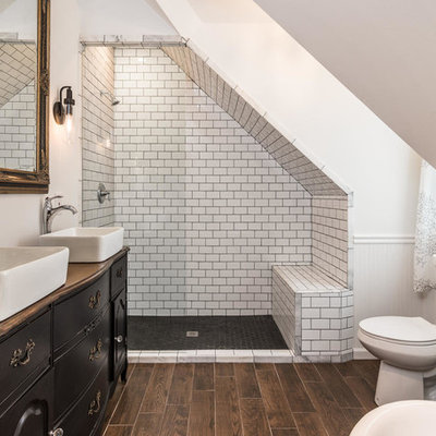 Example of a mid-sized eclectic master black and white tile and porcelain tile porcelain tile and brown floor alcove shower design in Nashville with a vessel sink, black cabinets, wood countertops, a two-piece toilet, white walls and brown countertops