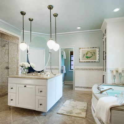 Example of an eclectic master multicolored tile and subway tile marble floor and beige floor bathroom design in Other with glass-front cabinets, white cabinets, blue walls, an undermount sink, granite countertops and a hinged shower door