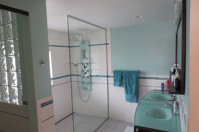 デンバーにある中くらいなエクレクティックスタイルのおしゃれなマスターバスルーム (白いタイル、サブウェイタイル、ガラスの洗面台、青い洗面カウンター) の写真