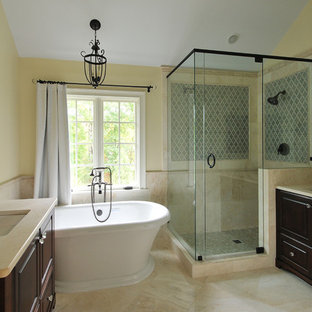 Inspiration for a traditional bathroom in Atlanta with a freestanding tub, yellow walls and travertine.