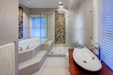 Example of a mid-sized trendy master beige tile and porcelain tile porcelain tile and beige floor bathroom design in Cleveland with a vessel sink, flat-panel cabinets, light wood cabinets, wood countertops, a one-piece toilet, beige walls and a hinged shower door
