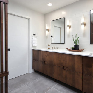 Inspiration for a mid-sized mid-century modern master gray tile and porcelain tile porcelain tile, gray floor, double-sink and wood wall bathroom remodel in Phoenix with flat-panel cabinets, medium tone wood cabinets, a one-piece toilet, white walls, an undermount sink, quartz countertops, white countertops, a niche and a built-in vanity