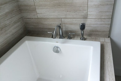 Modelo de cuarto de baño moderno con bañera encastrada, baldosas y/o azulejos marrones y baldosas y/o azulejos de porcelana