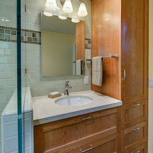 Photo of a small traditional 3/4 bathroom in San Francisco with an undermount sink, shaker cabinets, medium wood cabinets, engineered quartz benchtops, a corner shower, a two-piece toilet, green tile, ceramic tile, yellow walls, mosaic tile floors, white floor, a sliding shower screen, beige benchtops, a niche, a shower seat, a single vanity and a built-in vanity.