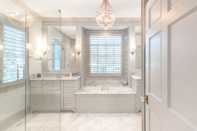 Example of a large classic master gray tile and marble tile marble floor and gray floor bathroom design in Charlotte with raised-panel cabinets, gray cabinets, gray walls, an undermount sink, marble countertops and a hinged shower door