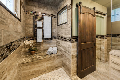 Large mountain style master beige tile and porcelain tile pebble tile floor doorless shower photo in Providence with raised-panel cabinets, dark wood cabinets, a two-piece toilet, green walls, a trough sink and granite countertops