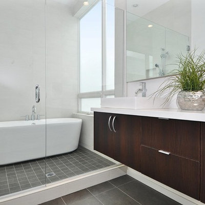 Bathroom - mid-sized contemporary master porcelain tile porcelain tile bathroom idea in Seattle with a vessel sink, flat-panel cabinets, dark wood cabinets, white walls and quartz countertops