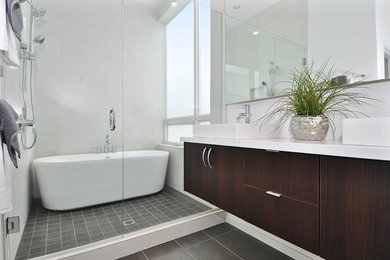 Inspiration for a medium sized contemporary ensuite bathroom in Seattle with a freestanding bath, a vessel sink, flat-panel cabinets, dark wood cabinets, a corner shower, porcelain tiles, white walls, porcelain flooring and engineered stone worktops.