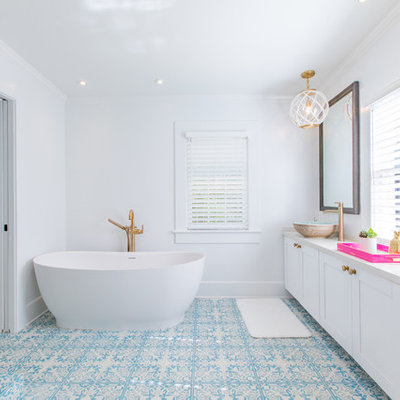 Inspiration for a tropical master mosaic tile floor and blue floor bathroom remodel in Miami with shaker cabinets, white cabinets, white walls, a vessel sink and a hinged shower door