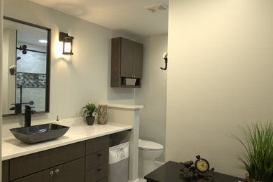 Small transitional 3/4 multicolored tile and porcelain tile porcelain tile and white floor bathroom photo in Baltimore with flat-panel cabinets, brown cabinets, a two-piece toilet, gray walls, a vessel sink, quartz countertops and white countertops