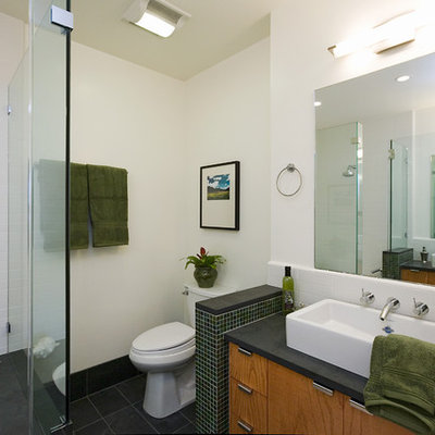 Tub/shower combo - contemporary white tile tub/shower combo idea in San Francisco with a vessel sink, flat-panel cabinets, medium tone wood cabinets, an undermount tub and a two-piece toilet
