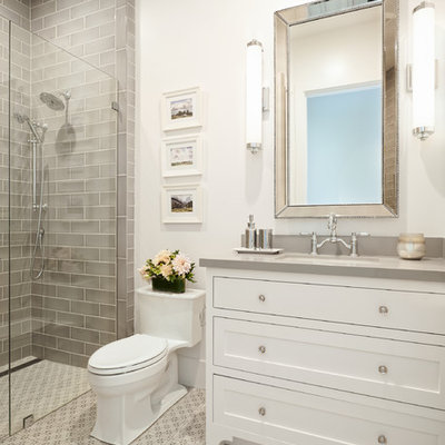 Inspiration for a farmhouse 3/4 gray tile and subway tile porcelain tile and gray floor alcove shower remodel in San Francisco with shaker cabinets, white cabinets, a one-piece toilet, white walls, an undermount sink, quartz countertops, a hinged shower door and gray countertops