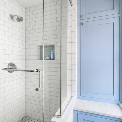 Example of a small classic kids' black and white tile and ceramic tile marble floor and gray floor corner shower design in Minneapolis with furniture-like cabinets, blue cabinets, a two-piece toilet, blue walls, an undermount sink, quartz countertops, a hinged shower door and white countertops