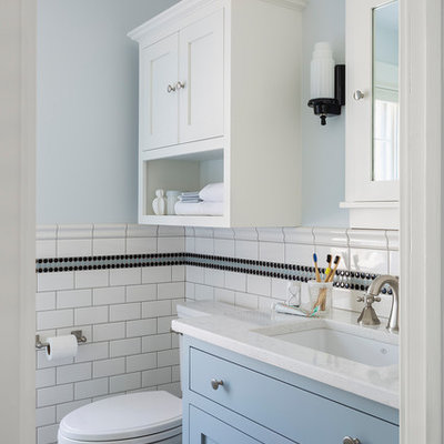 Inspiration for a small timeless kids' black and white tile and ceramic tile marble floor and gray floor corner shower remodel in Minneapolis with furniture-like cabinets, blue cabinets, a two-piece toilet, blue walls, an undermount sink, quartz countertops, a hinged shower door and white countertops