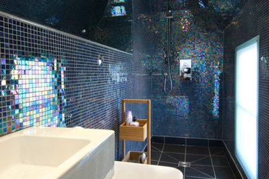This is an example of a contemporary shower room bathroom in London with an alcove shower, multi-coloured tiles, black floors and an open shower.