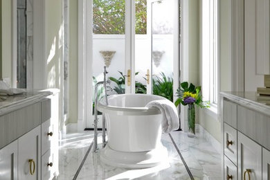 Elegant marble floor freestanding bathtub photo in Austin
