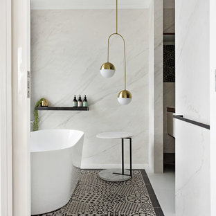 Photo of a contemporary bathroom in Geelong with a freestanding tub, white tile, white walls and multi-coloured floor.