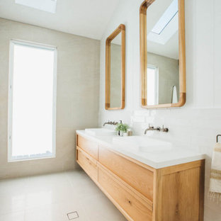 Photo of a large contemporary master bathroom in Central Coast with shaker cabinets, light wood cabinets, beige tile, porcelain tile, porcelain floors, a vessel sink, beige floor, white benchtops, a double vanity and a floating vanity.