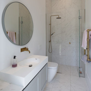 Inspiration for a small traditional shower room bathroom in Auckland with grey cabinets, a built-in shower, a one-piece toilet, grey tiles, marble tiles, white walls, marble flooring, marble worktops, grey floors, a hinged door, white worktops, recessed-panel cabinets and an integrated sink.