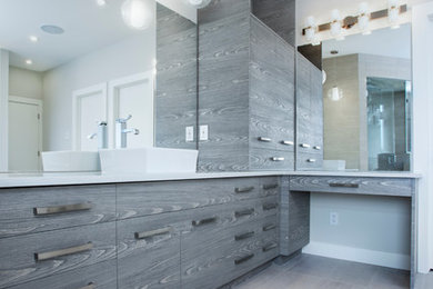 World-inspired ensuite bathroom in Other with flat-panel cabinets, grey cabinets, grey tiles, white walls and quartz worktops.
