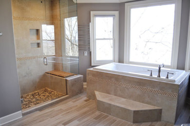 Inspiration for a large transitional master beige tile and stone tile vinyl floor and brown floor bathroom remodel in Atlanta with raised-panel cabinets, dark wood cabinets, a two-piece toilet, beige walls, a vessel sink, granite countertops, a hinged shower door and beige countertops