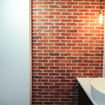 Exposed Brick Bathroom Accent Wall with Industrial Lighting