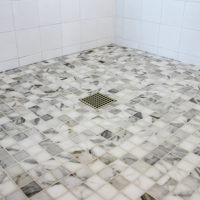 Example of a large cottage chic master gray tile, multicolored tile, white tile and mosaic tile marble floor bathroom design in New York with a drop-in sink, marble countertops, raised-panel cabinets, white cabinets, a two-piece toilet and white walls