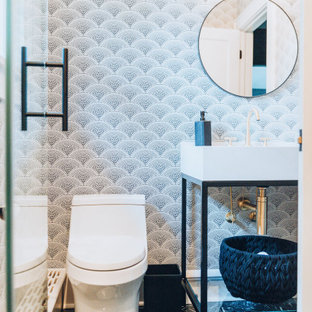 Alcove shower - mid-sized modern kids' gray tile and ceramic tile ceramic tile, black floor, single-sink, coffered ceiling and wallpaper alcove shower idea in New York with white cabinets, a one-piece toilet, multicolored walls, a pedestal sink, marble countertops, a hinged shower door, white countertops and a freestanding vanity