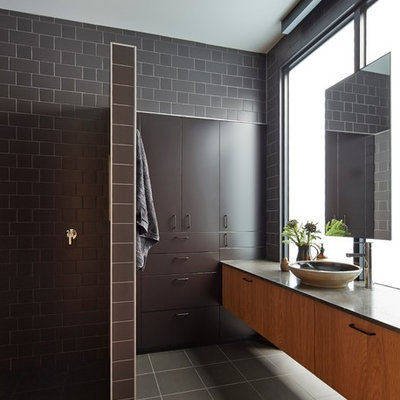 Mid-sized trendy master brown tile and ceramic tile ceramic tile bathroom photo in Melbourne with a vessel sink, furniture-like cabinets, dark wood cabinets and brown walls